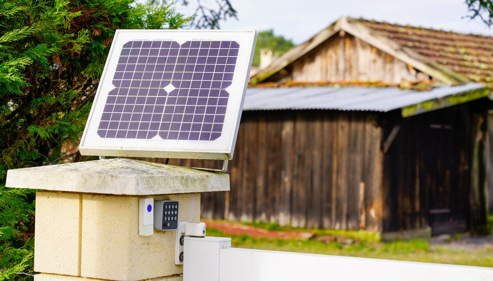 Solar panel on top of a gate post of a barn house